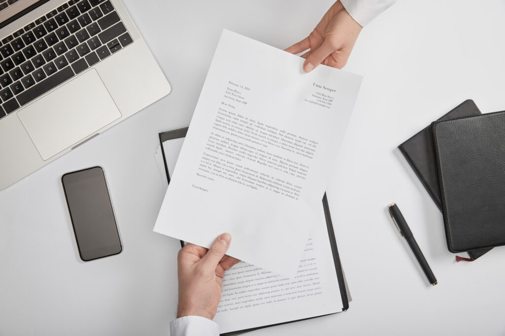 top view of clerks holding contract at workplace with copy space top view of clerks holding contract at workplace with copy space